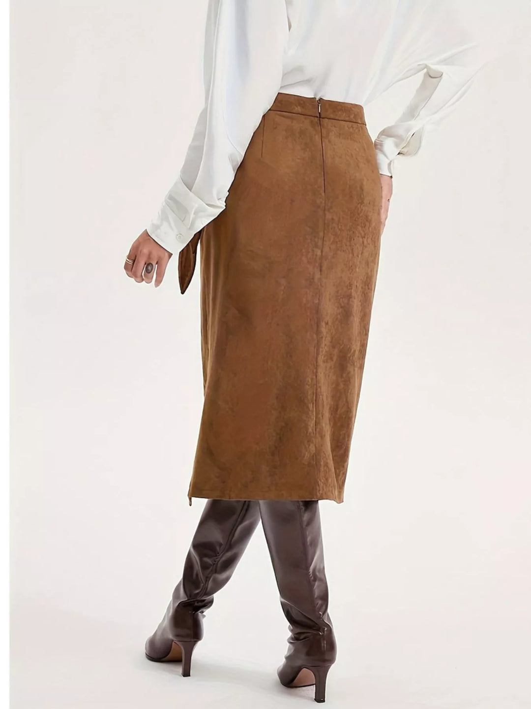 Back view of the camel brown midi skirt with tall brown boots