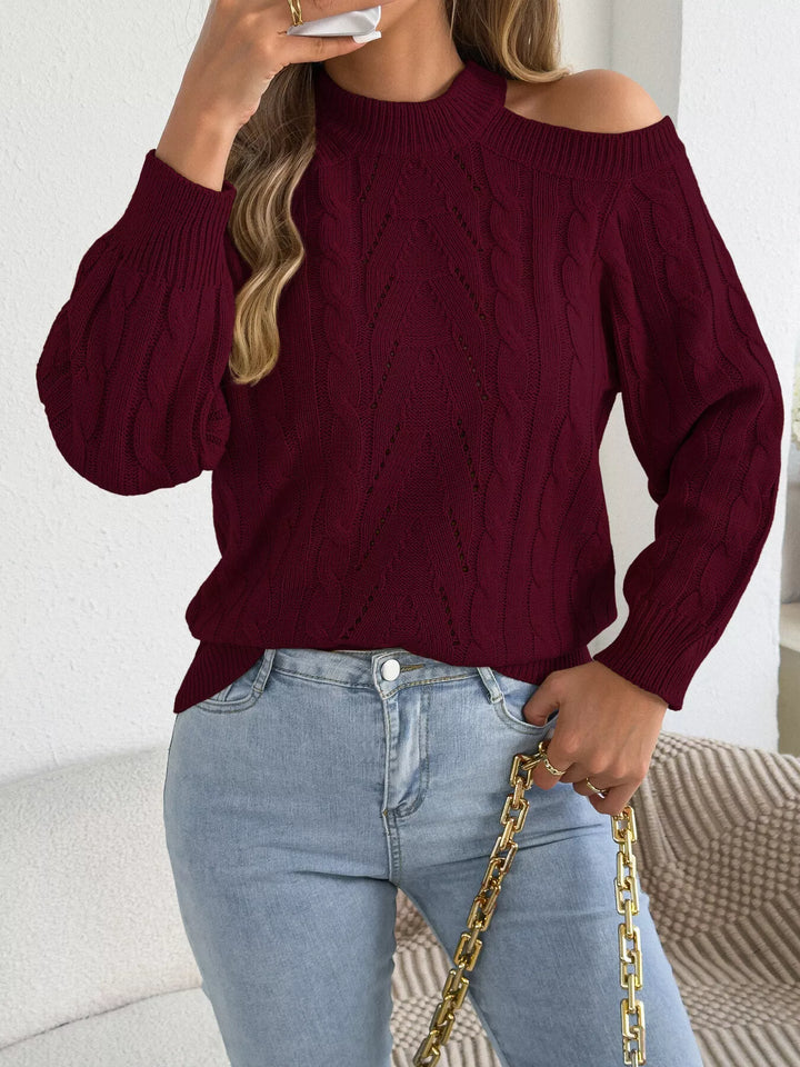 Burgundy cable knit sweater with a gold chain bag