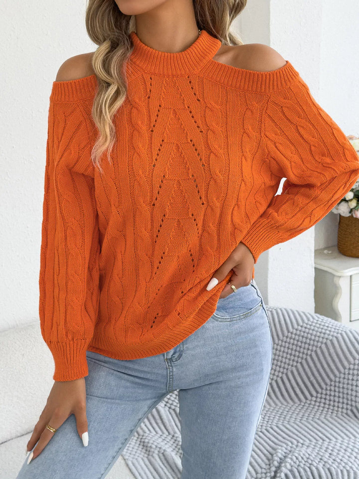 Orange cold shoulder sweater worn with hands on the hips