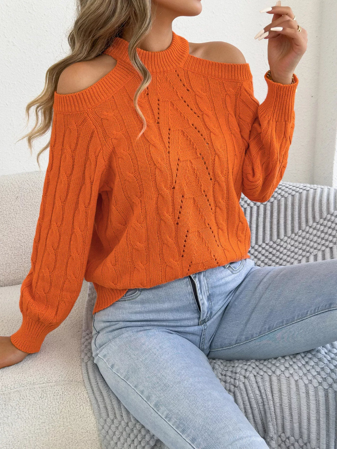 Women's mock neck sweater in orange with cable knit and cold shoulder cutouts