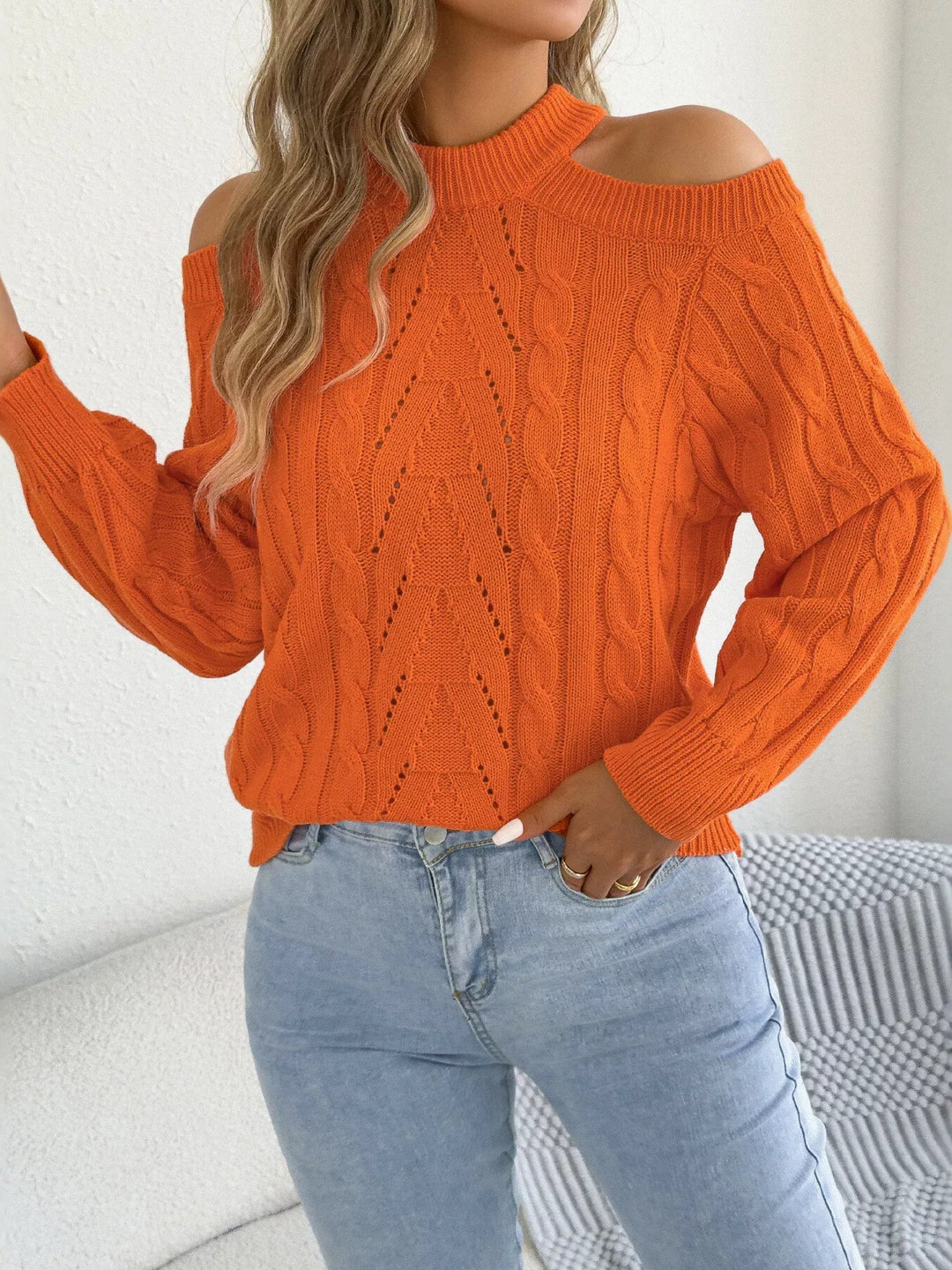 Orange mock neck sweater with shoulder cutouts, three quarter view