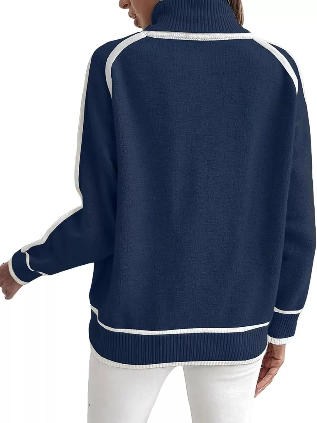 Navy mock neck sweater with white piping, back view with white pants