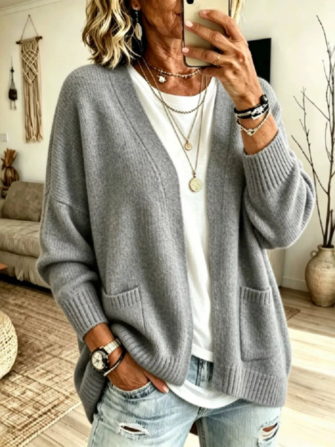 Gray oversized V neck open front cardigan with pockets, layered over a white top