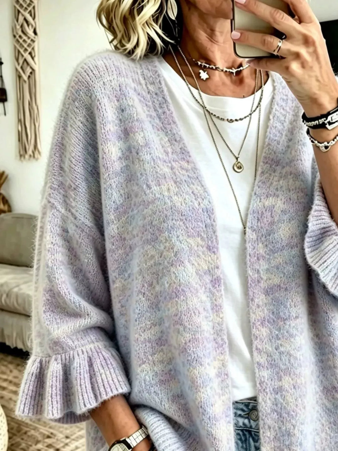 Lavender knit cardigan worn open, three-quarter pose with layered necklaces