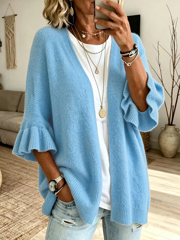 Light blue relaxed cardigan with ruffled sleeves over a white top