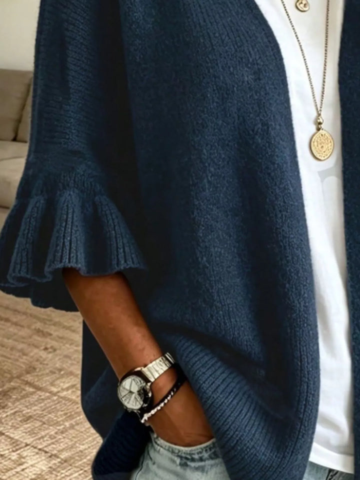Navy cardigan close-up of the ruffled cuff and draped front