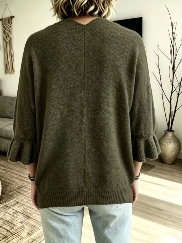Olive green cardigan back view showing the center seam and ruffle sleeve ends