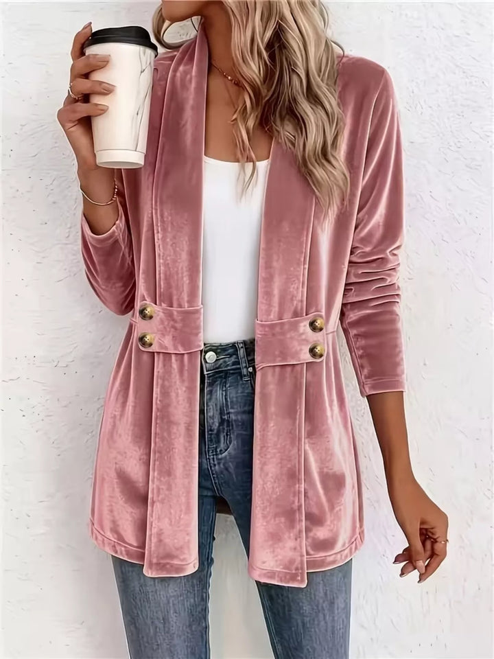 Dusty pink velvet-look open front cardigan with belted waist, holding a coffee cup
