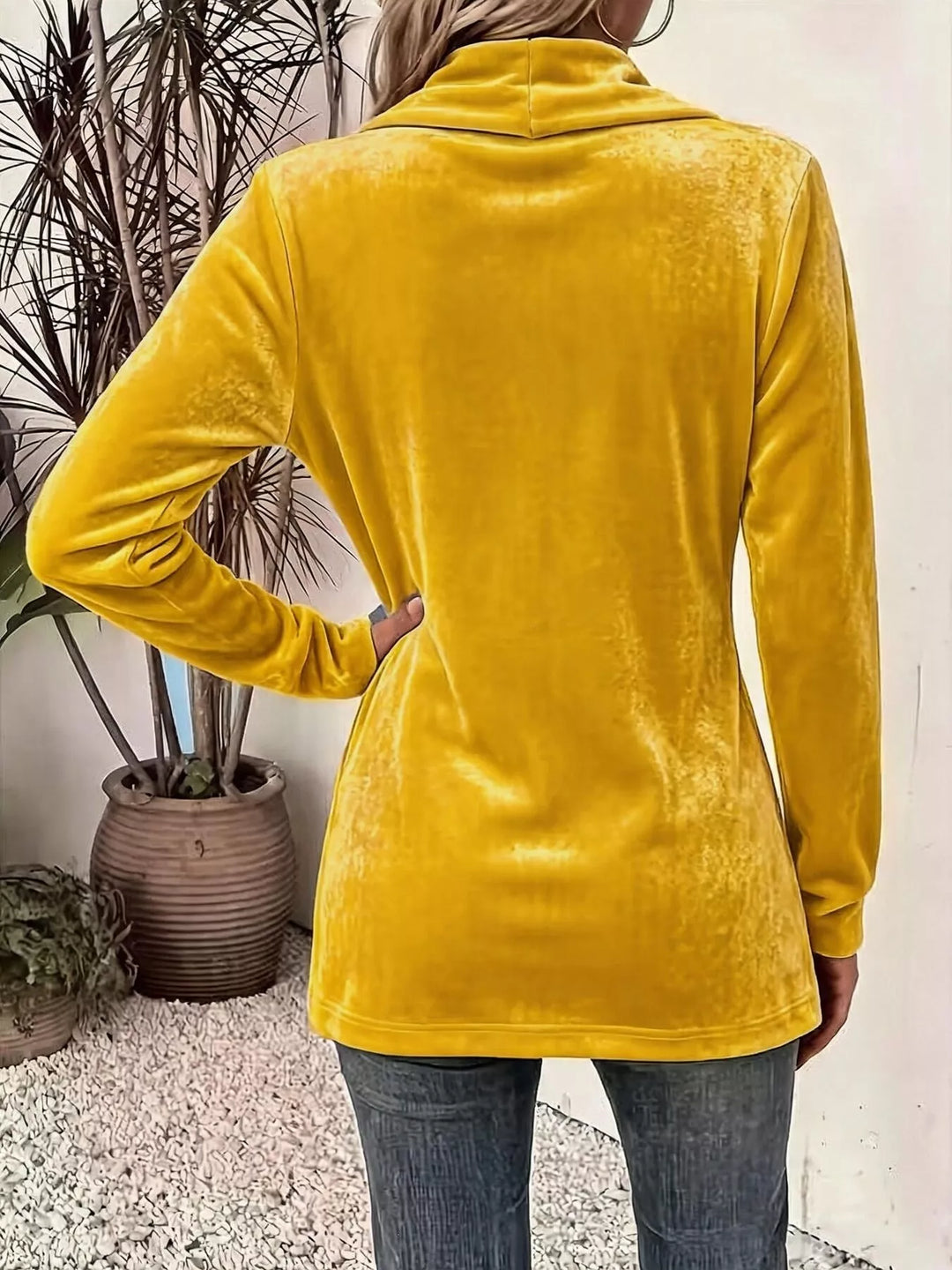 Back view of the mustard shawl collar cardigan with hand on hip