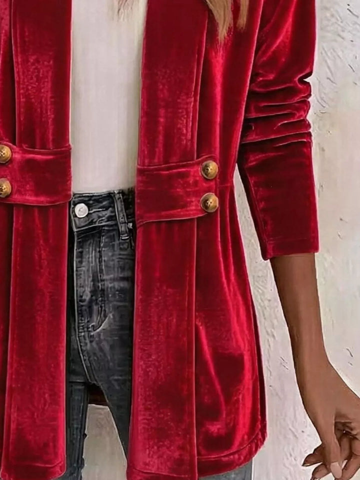 Close-up of the red velvet-look cardigan waist belt with gold buttons