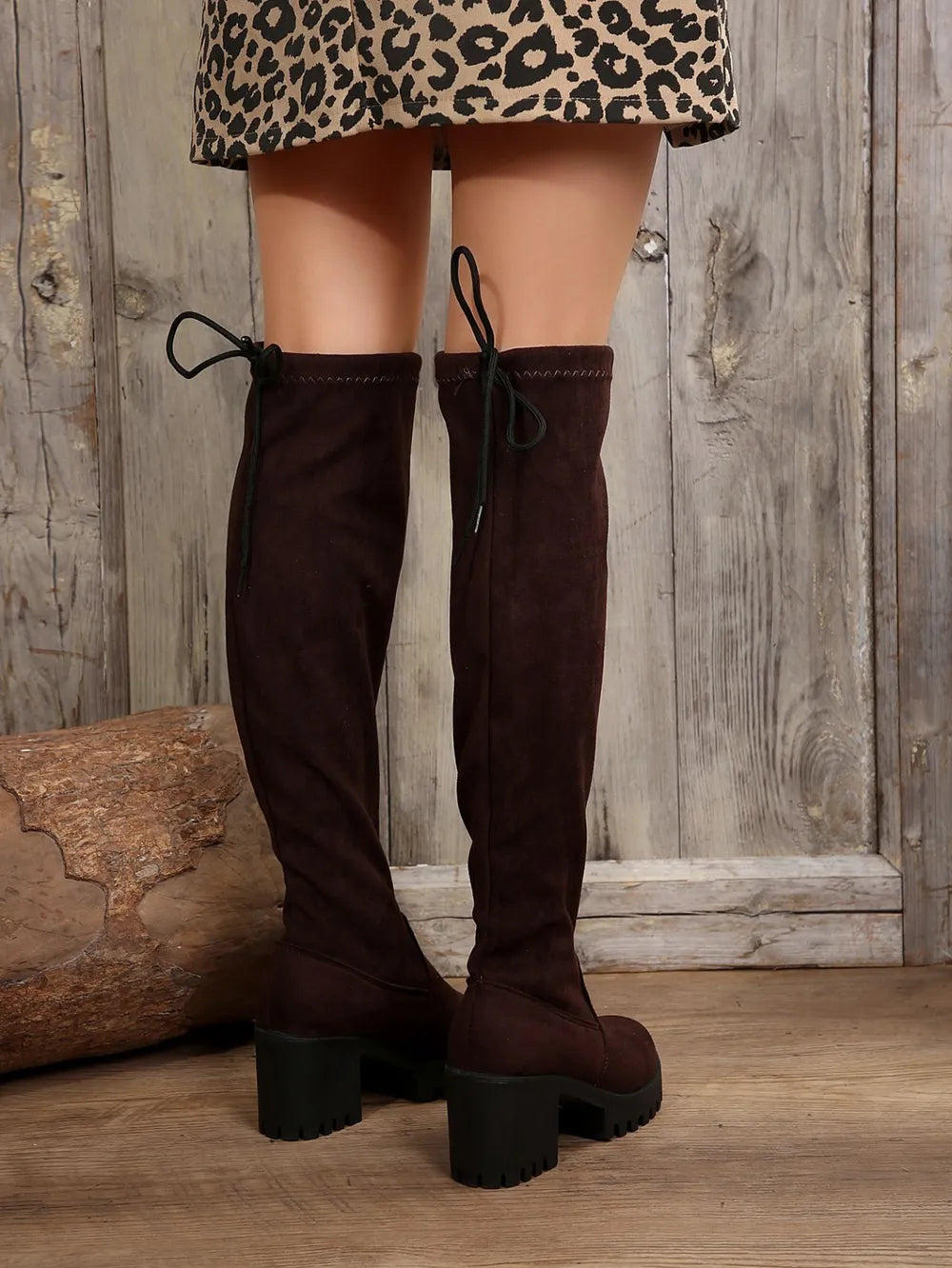 Back view of brown over the knee boots with the tie bow at the top