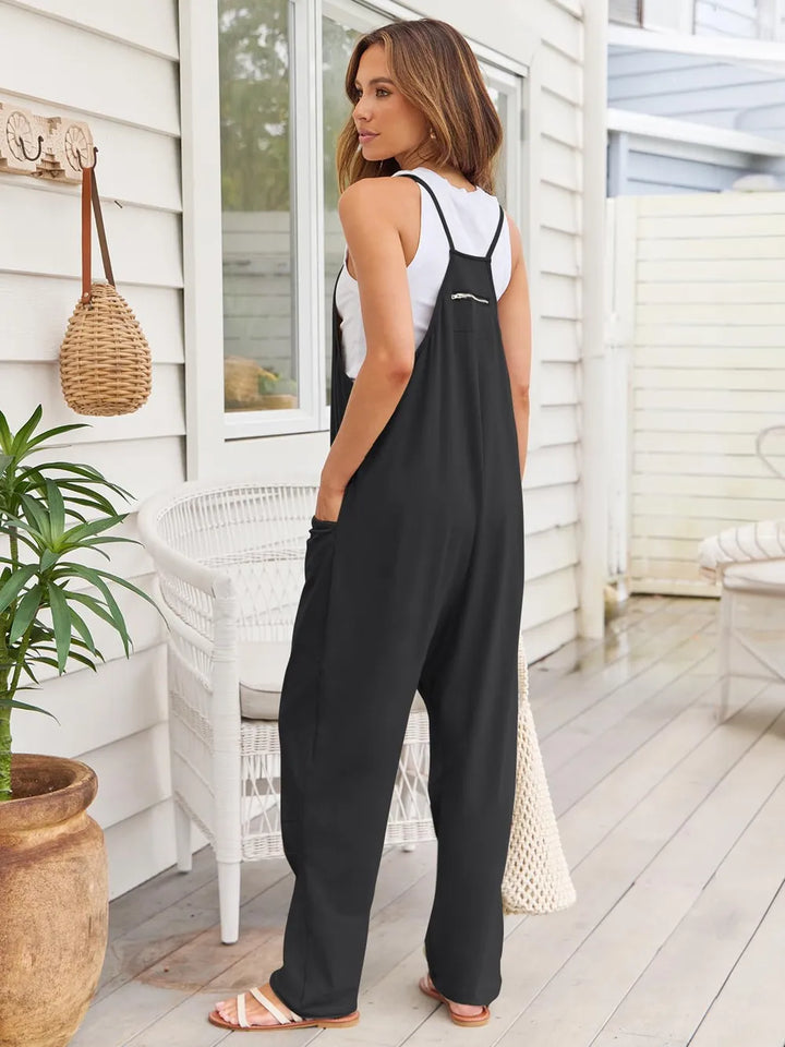 Back view of the black overalls with wide straps and relaxed leg