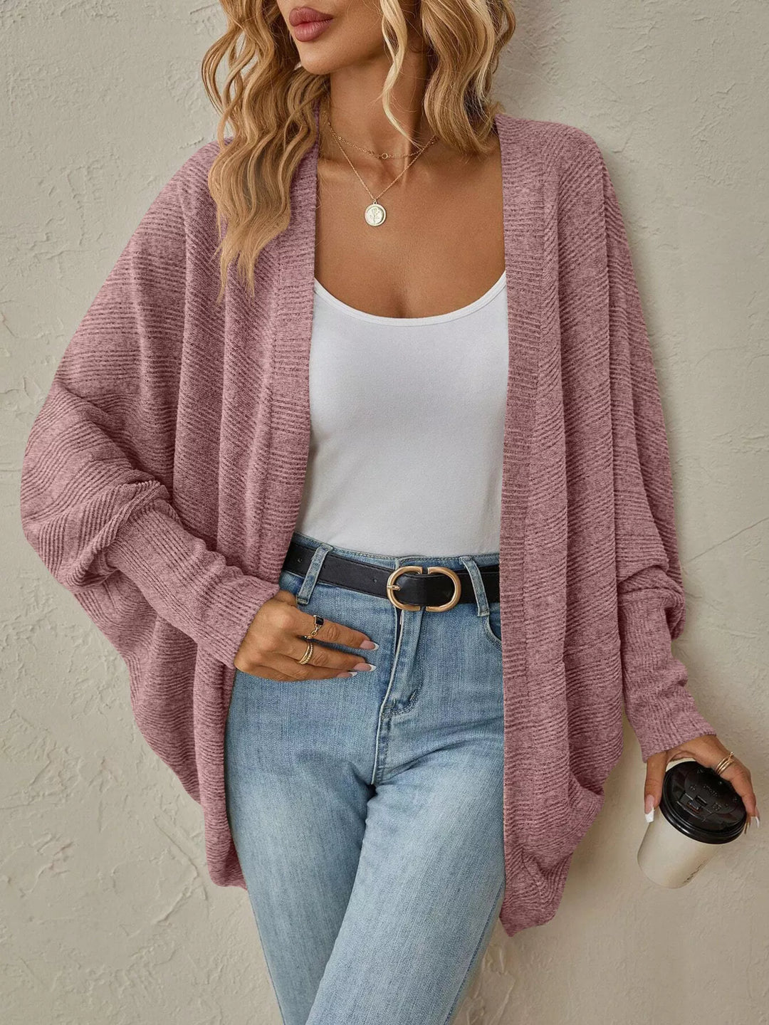 Women's dusty rose oversized cardigan with open front and batwing sleeves, with a coffee cup