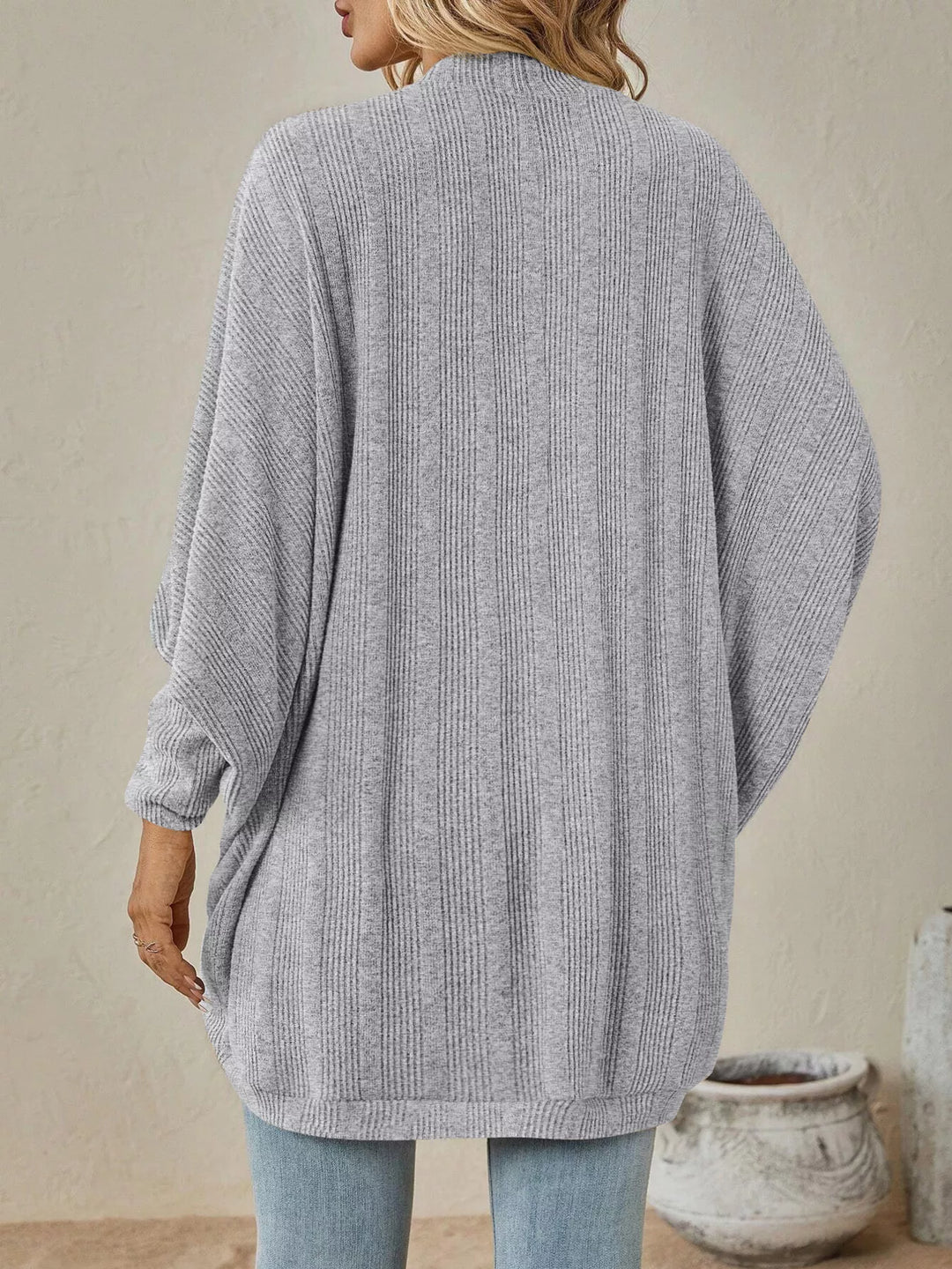 Back view of the light gray oversized cardigan with batwing sleeves