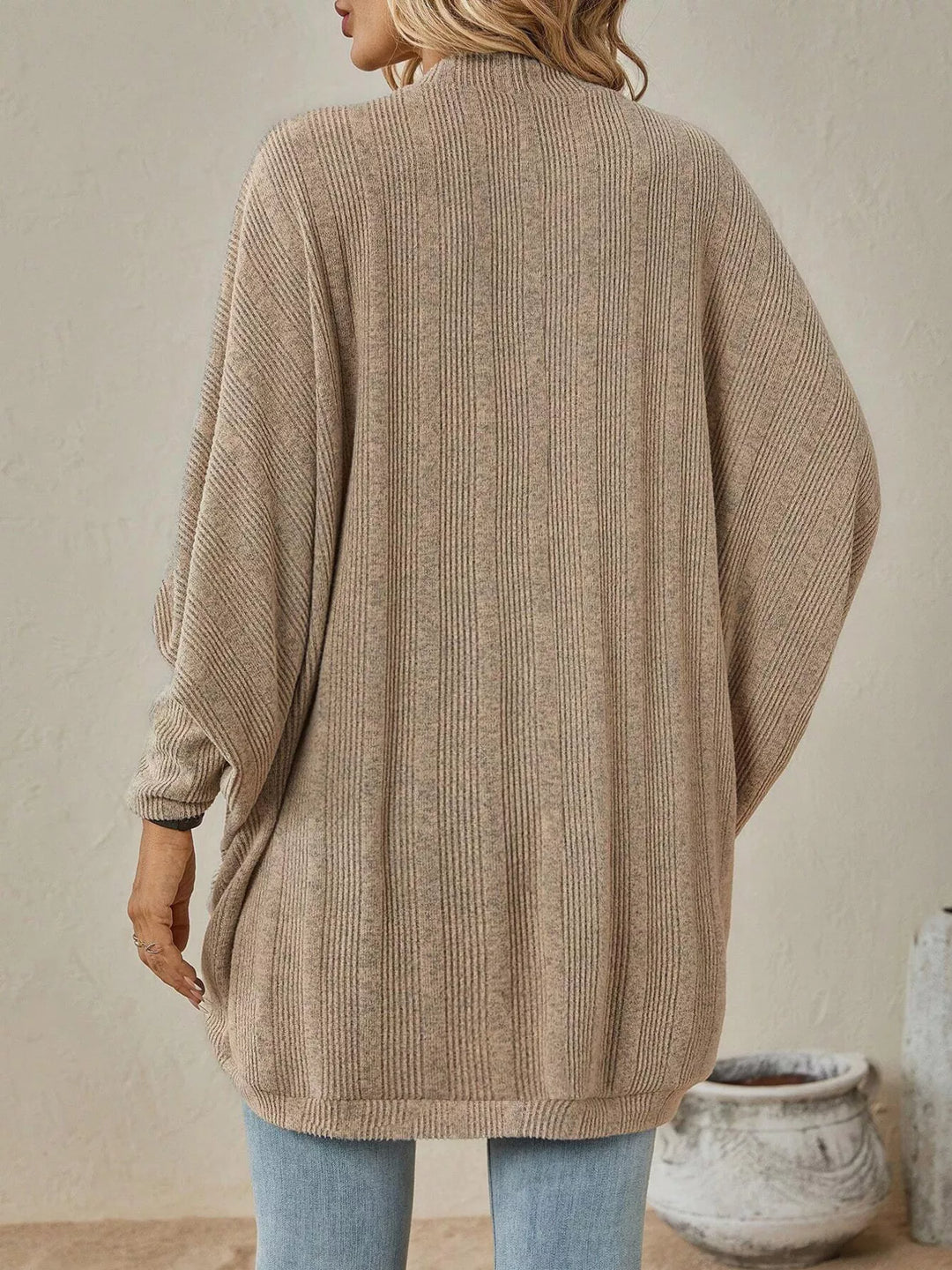 Back view of the tan oversized cardigan with batwing sleeves