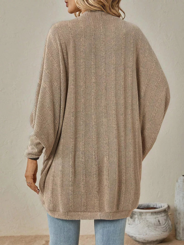 Back view of the tan oversized cardigan with batwing sleeves