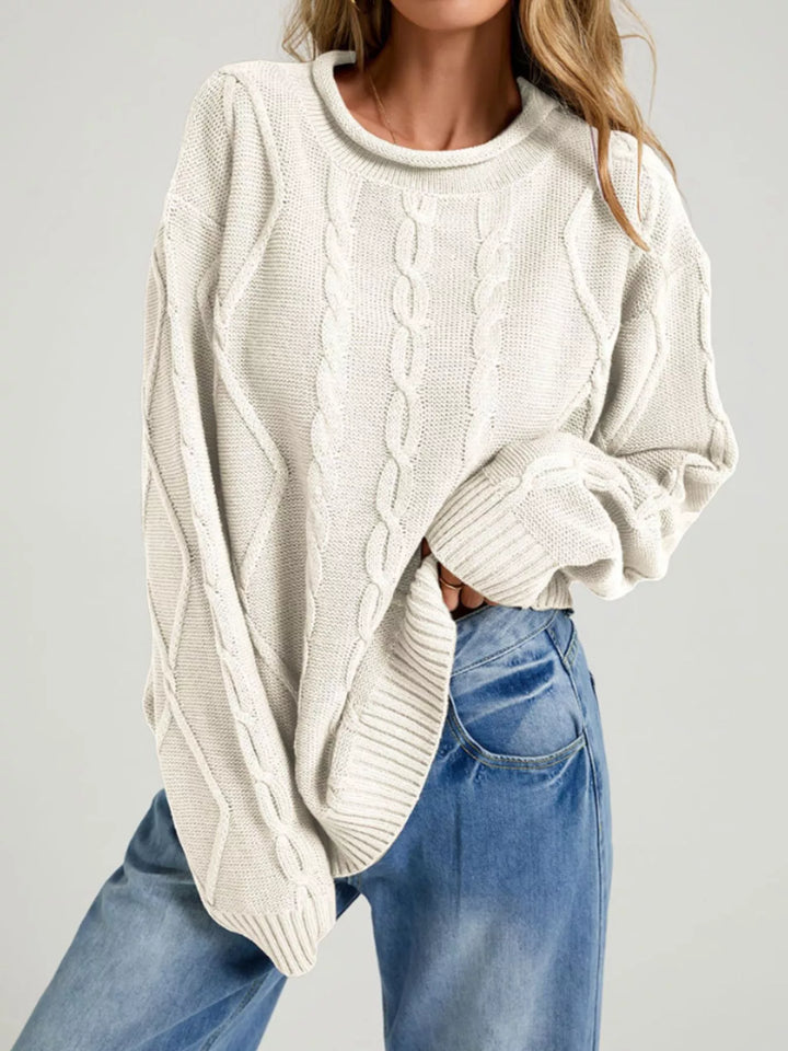 Cream oversized cable knit sweater with rolled neck and long sleeves, front view