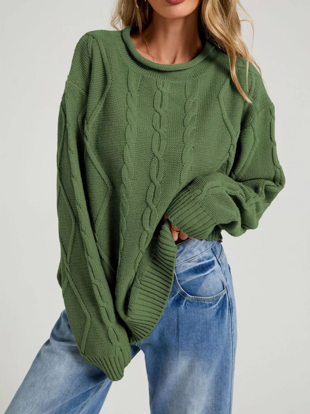 Forest green oversized cable knit sweater with rolled neck, front view
