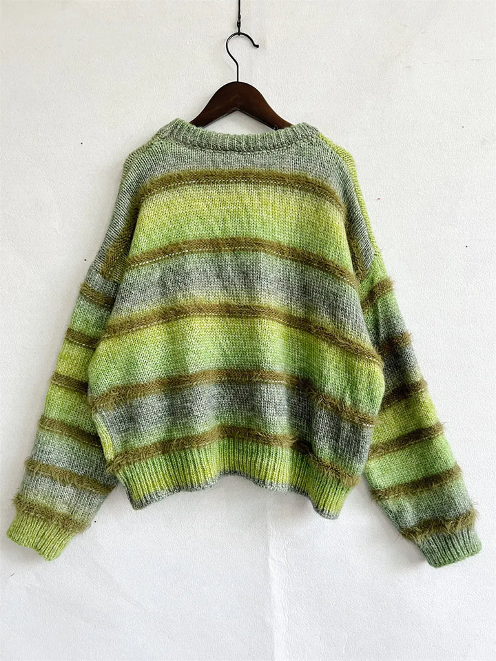 Green fuzzy knit sweater on a hanger with sleeves spread