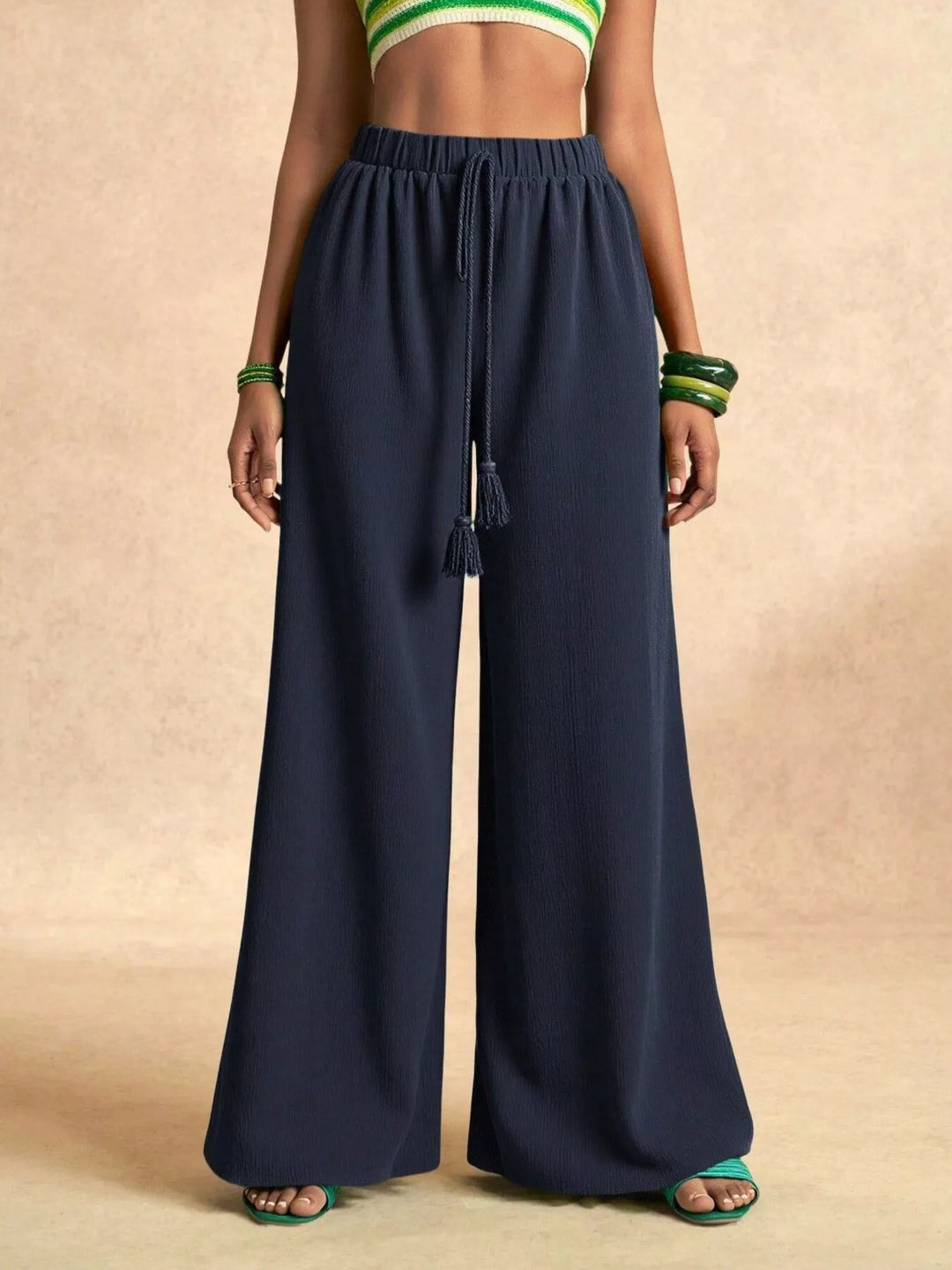 Navy wide leg palazzo pants, straight front view with gold bracelets