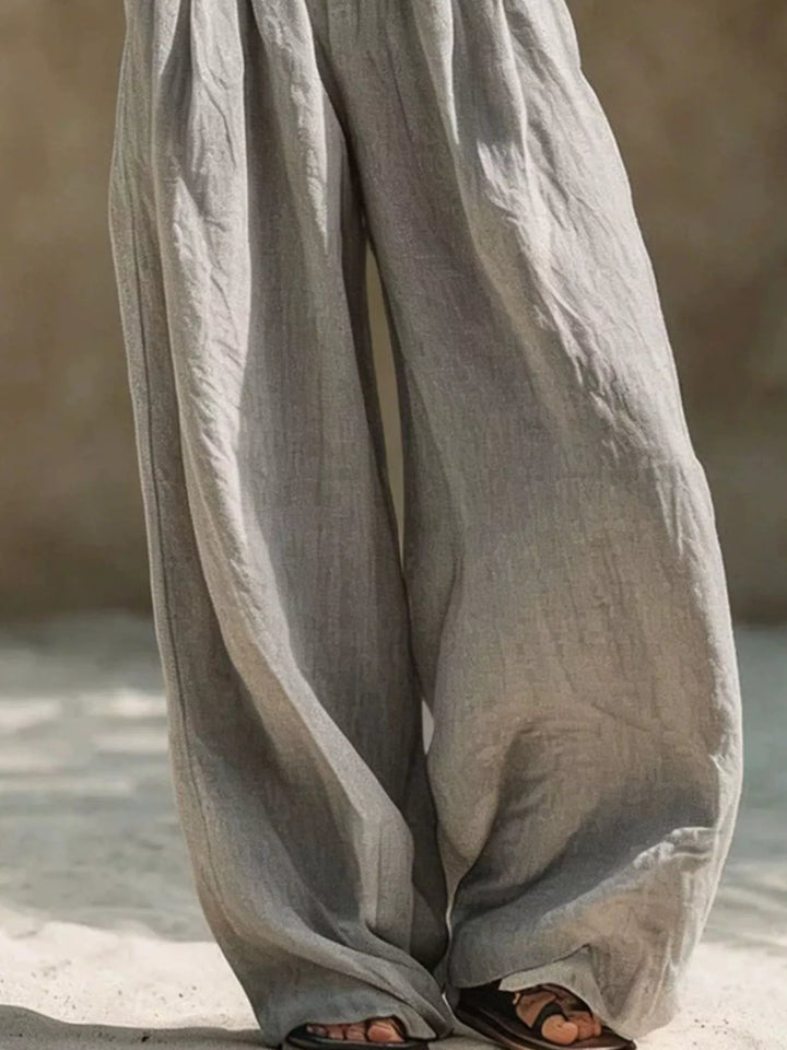 Gray wide leg palazzo pants showing the long relaxed drape toward the hem