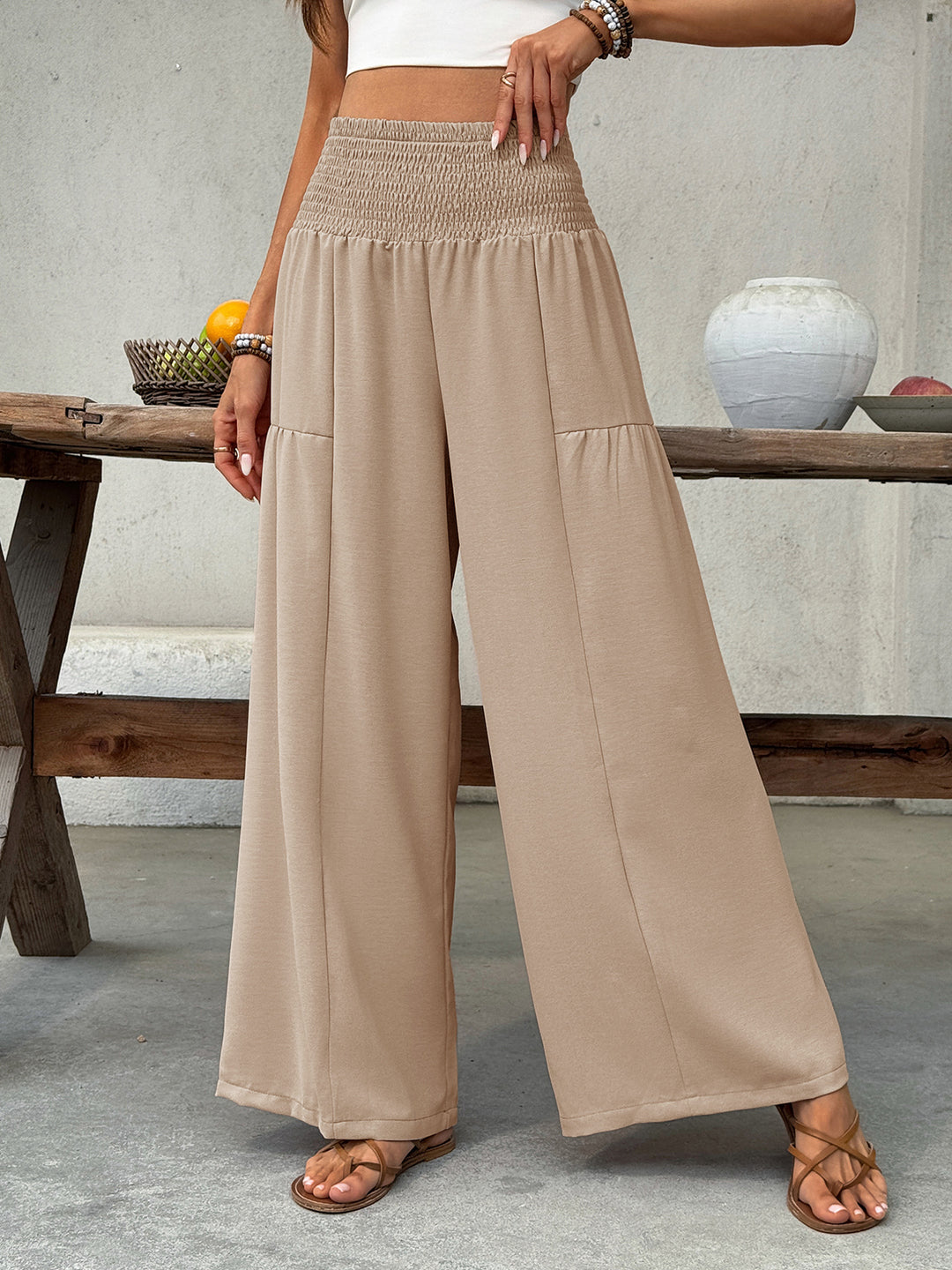 Women's tan palazzo pants with very wide legs and smocked high waist
