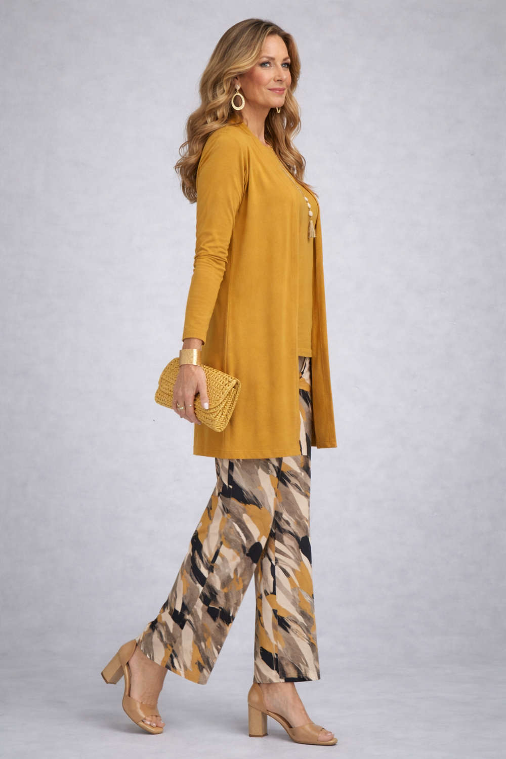 Side view of the mustard cardigan with the black, cream and mustard print pants