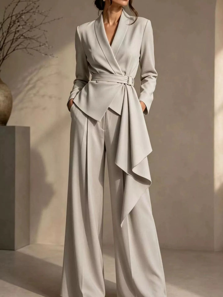 Beige wrap blazer and wide leg pants set with hands in pockets, front view