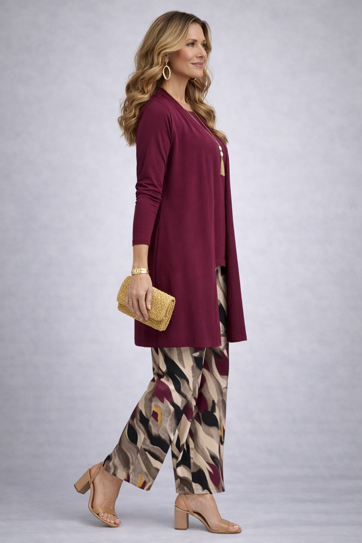 Side view of the burgundy cardigan and the beige, black and berry print pants