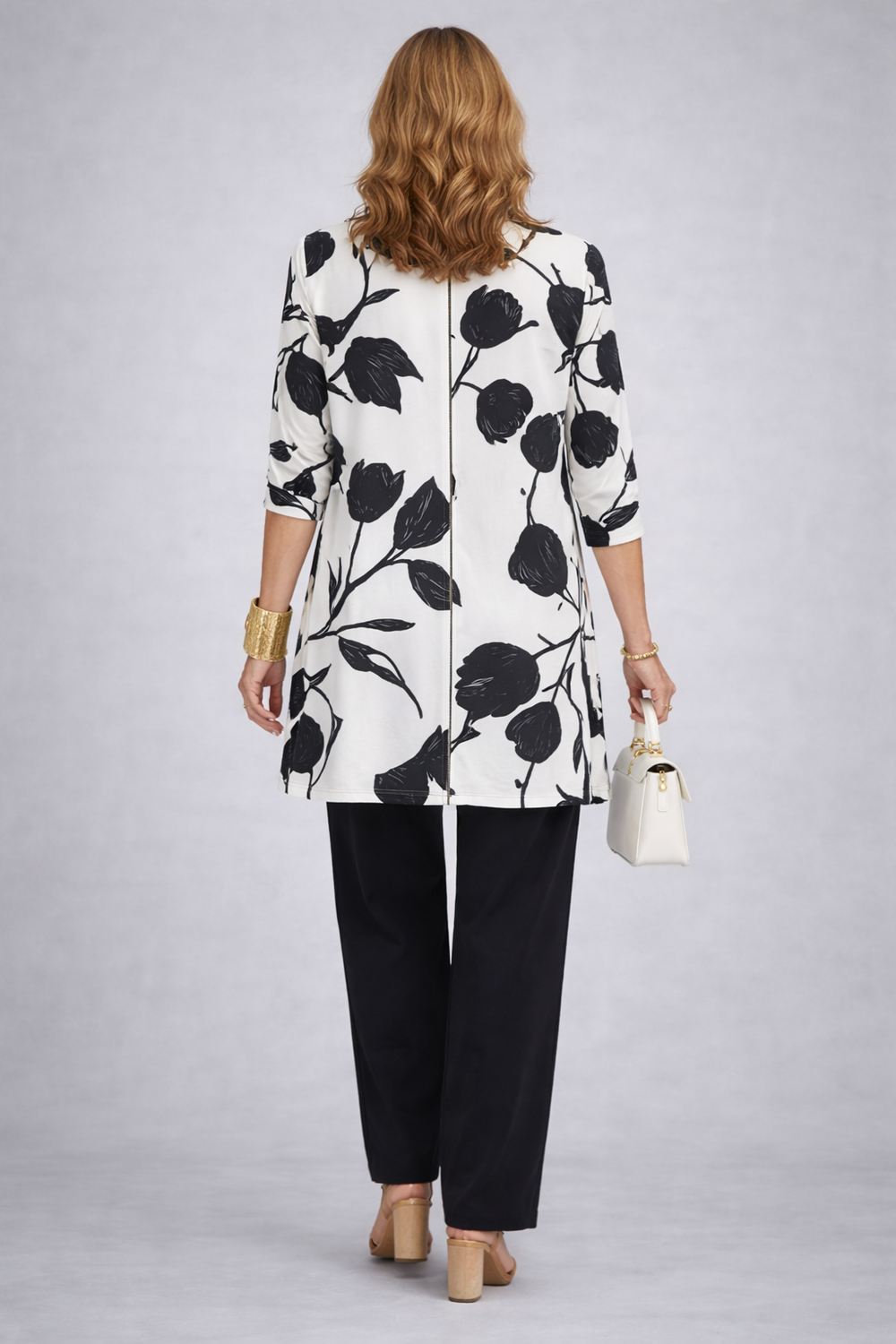 Back view of the black and ivory tulip print cardigan with a center seam