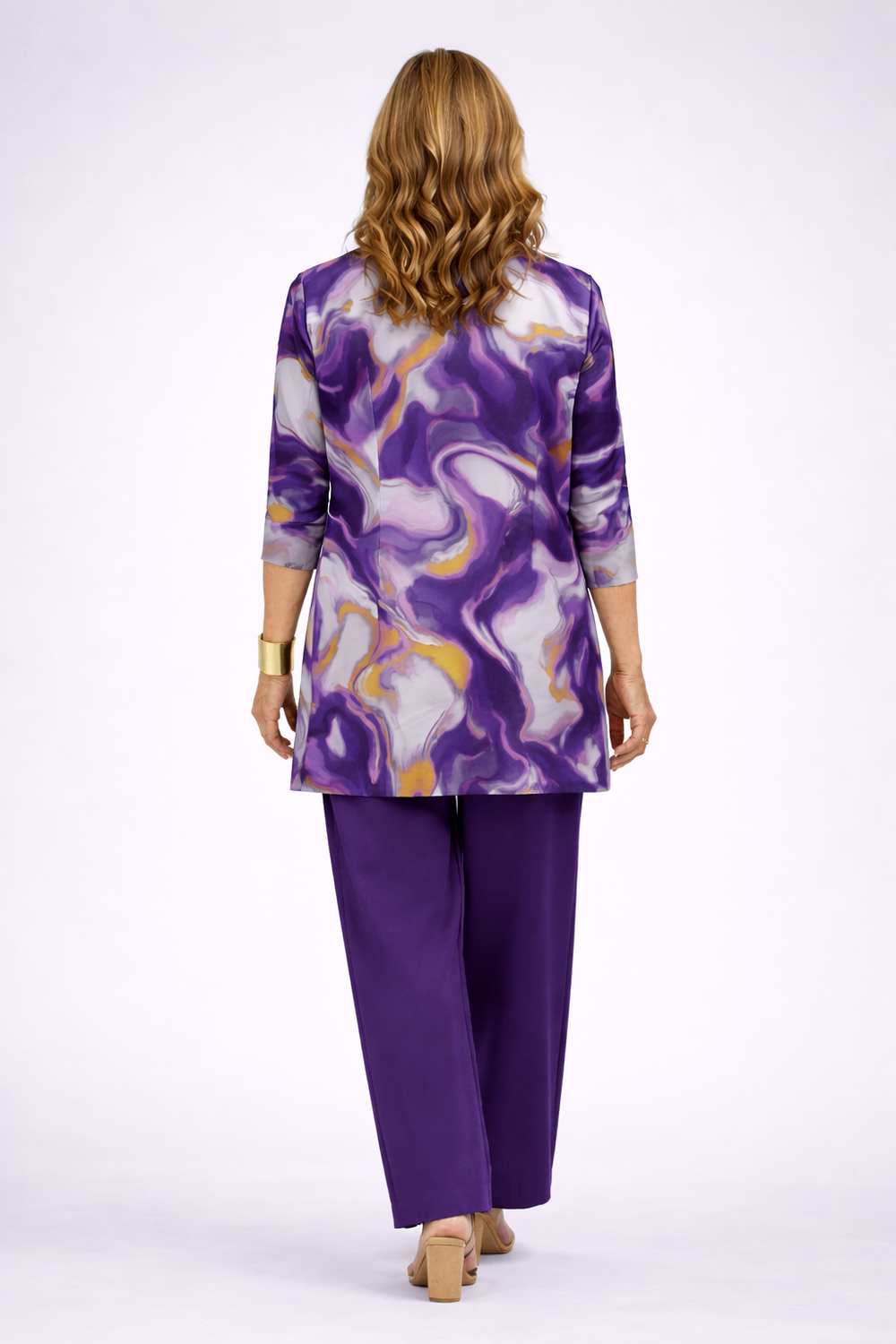 Back view of the purple, lilac and gold swirl print cardigan over purple pants