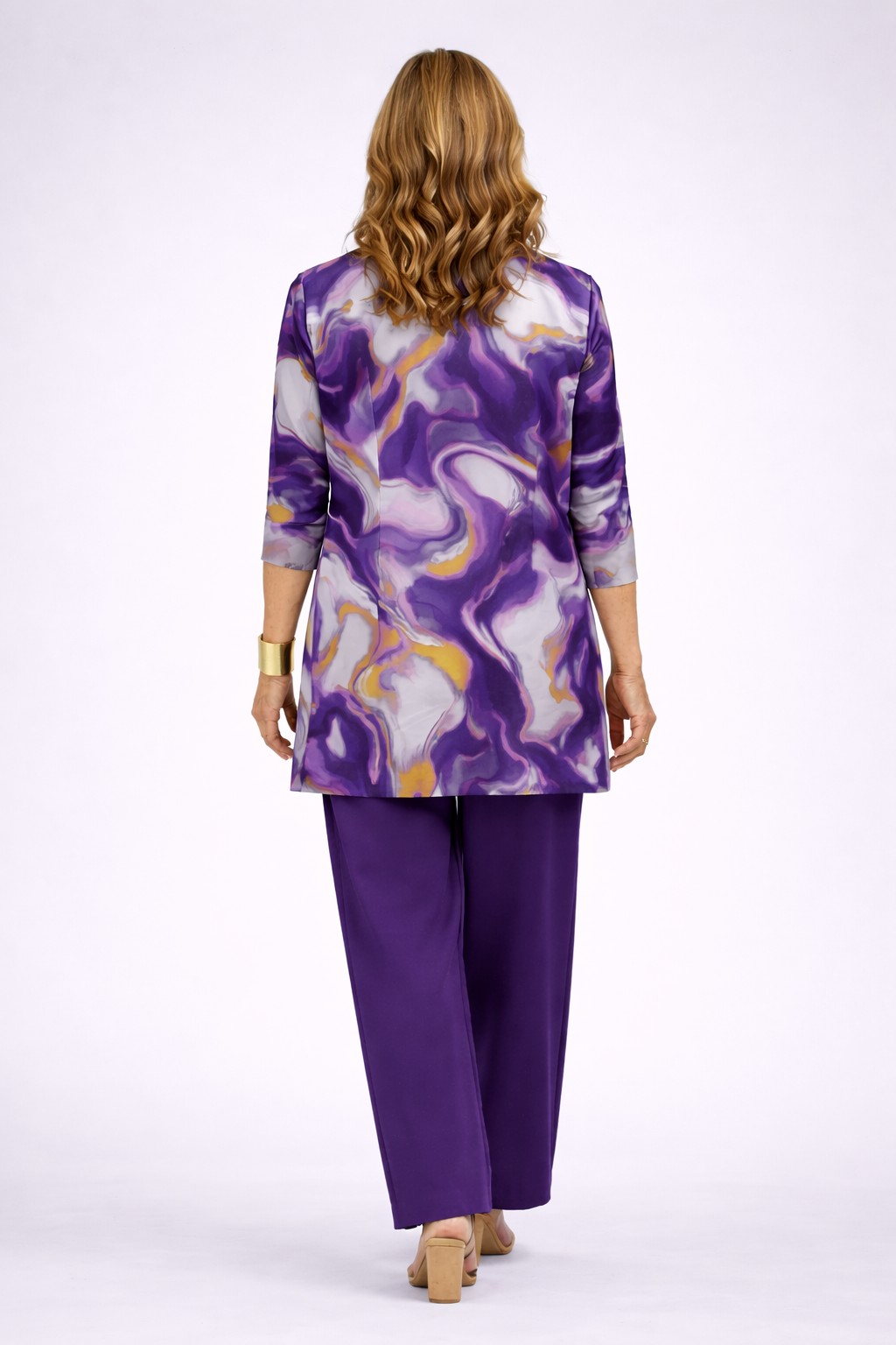 Back view of the purple, lilac and gold swirl print cardigan over purple pants