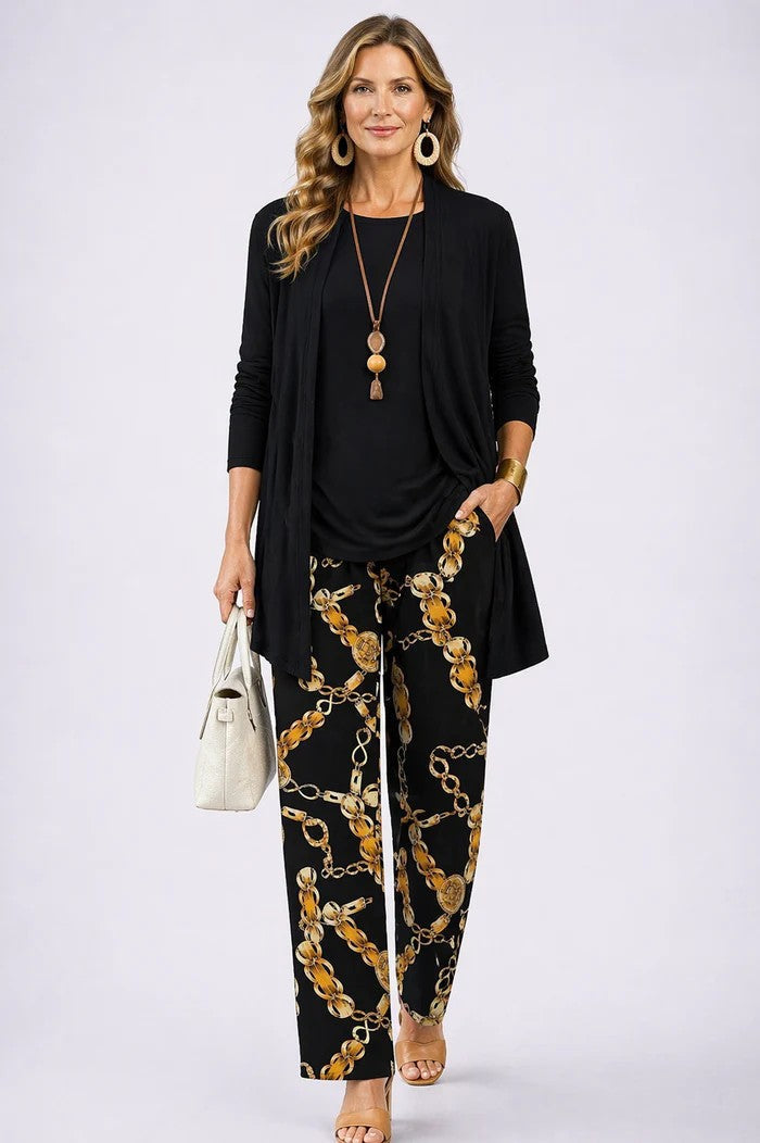 Black cardigan and top paired with gold chain print pants