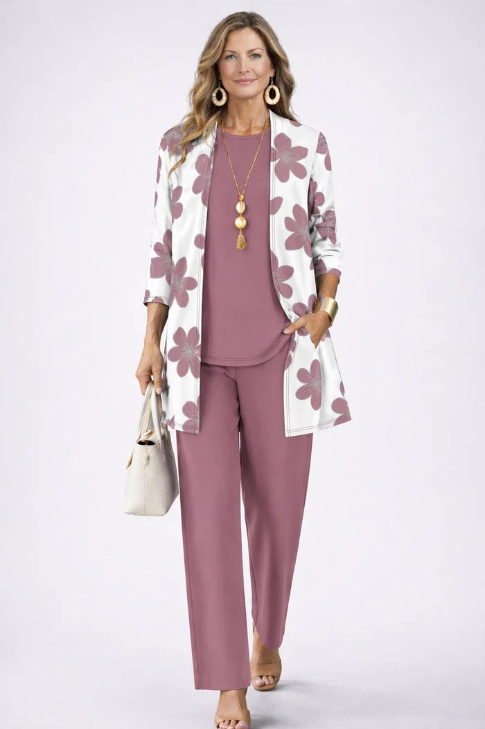 White cardigan with mauve flower print over a mauve top and pants