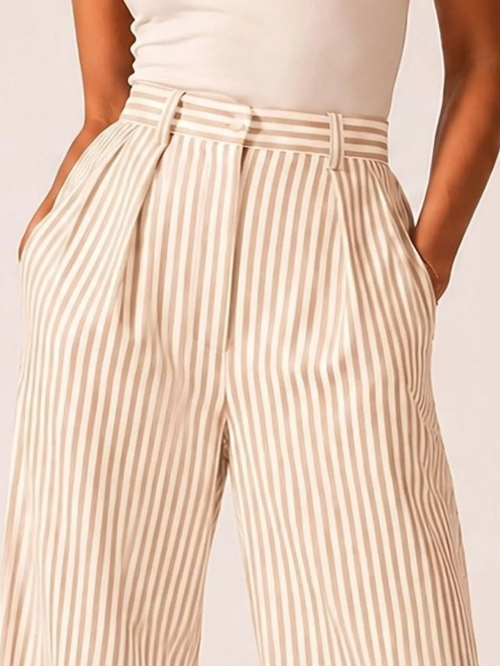 Cream pinstripe pleated pants close-up of the waistband and stripe pattern