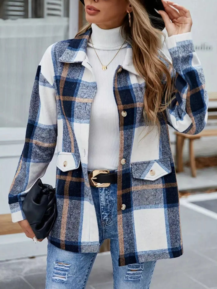 Front view of the navy plaid shacket with chest pockets over a white turtleneck