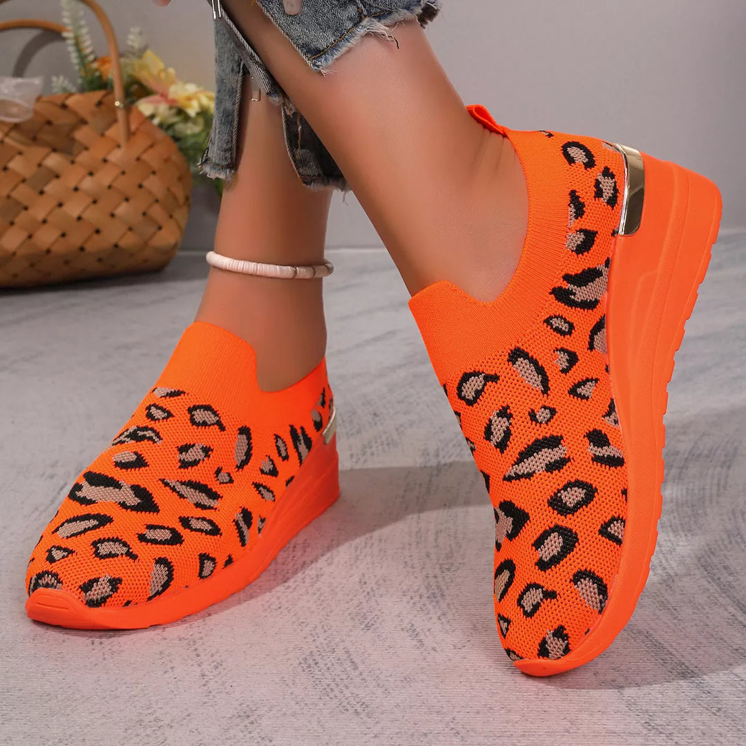 Orange leopard print slip on knit sneakers with a hidden wedge sole