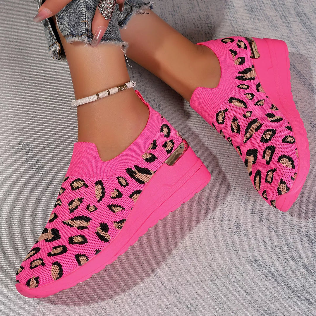 Pink leopard print platform sneakers worn together, angled view