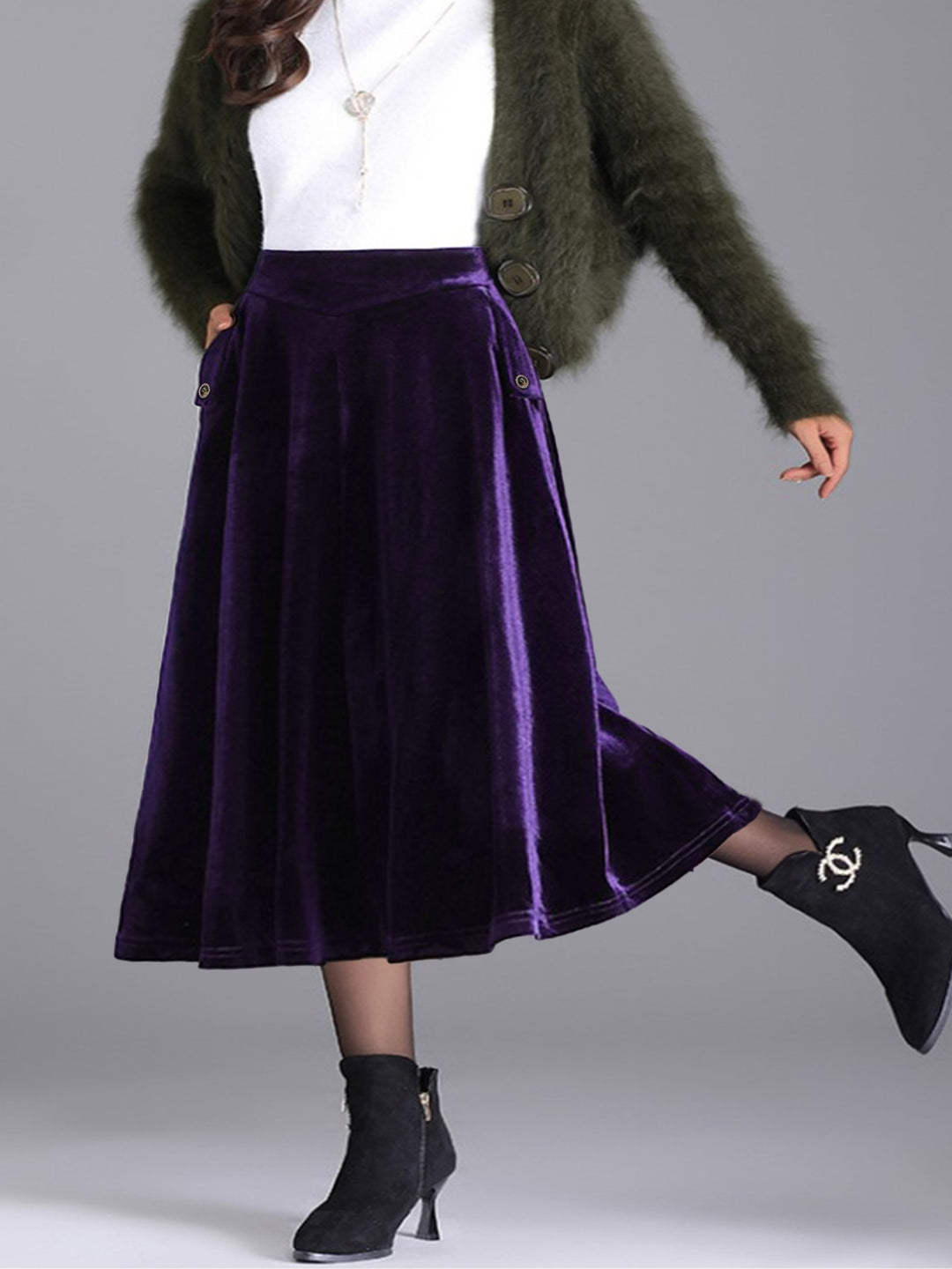 Deep purple velvet-look A line skirt with a white top and green fuzzy cardigan