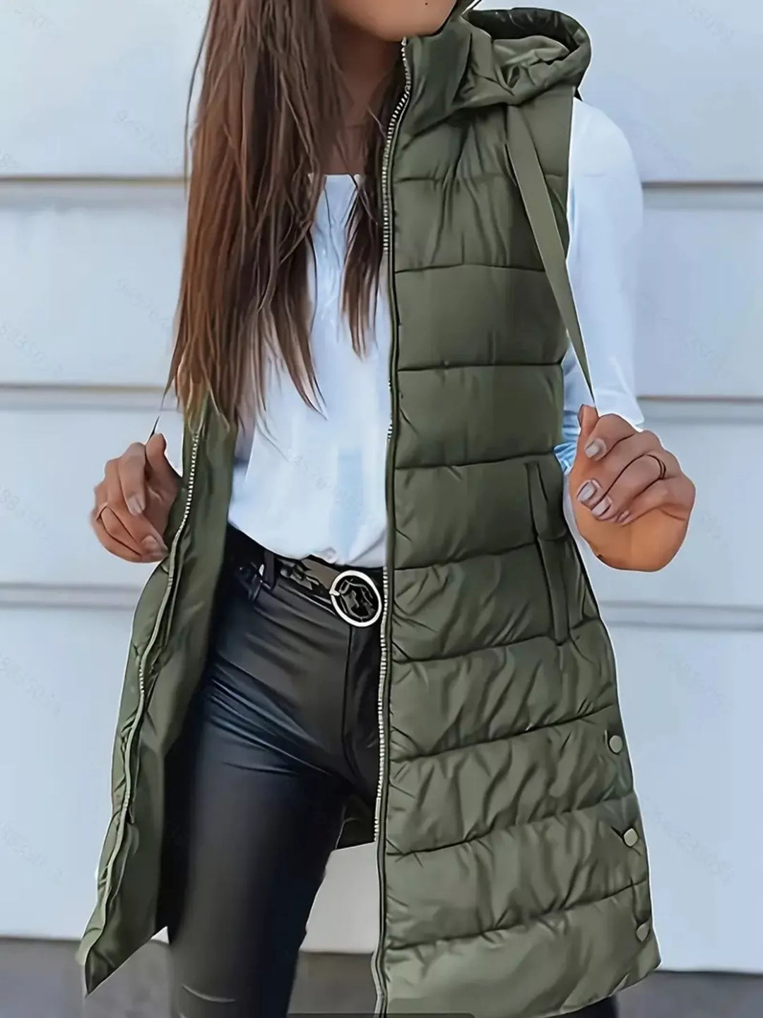 Women's puffer vest in army green, longline quilted hooded zip front, worn over a white top