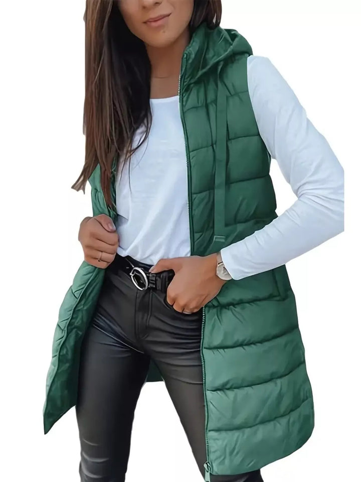 Emerald green hooded quilted vest, longline fit, worn open over a white top