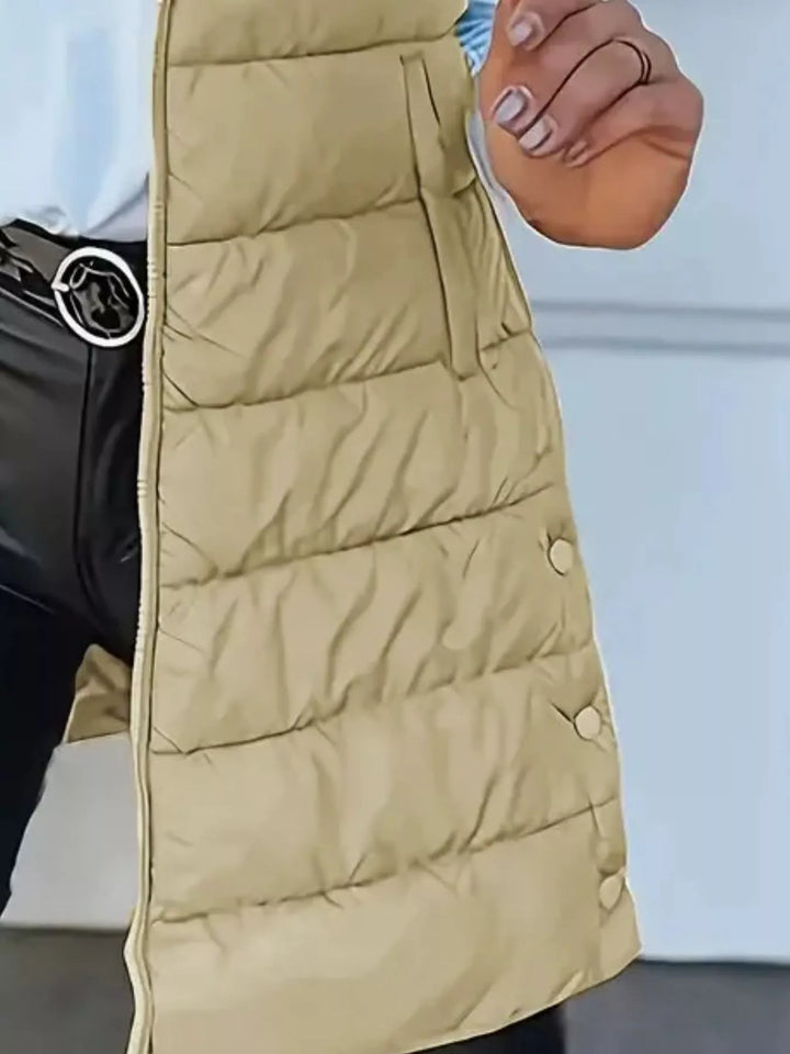 Close-up of the khaki quilted vest side pocket and snap detail