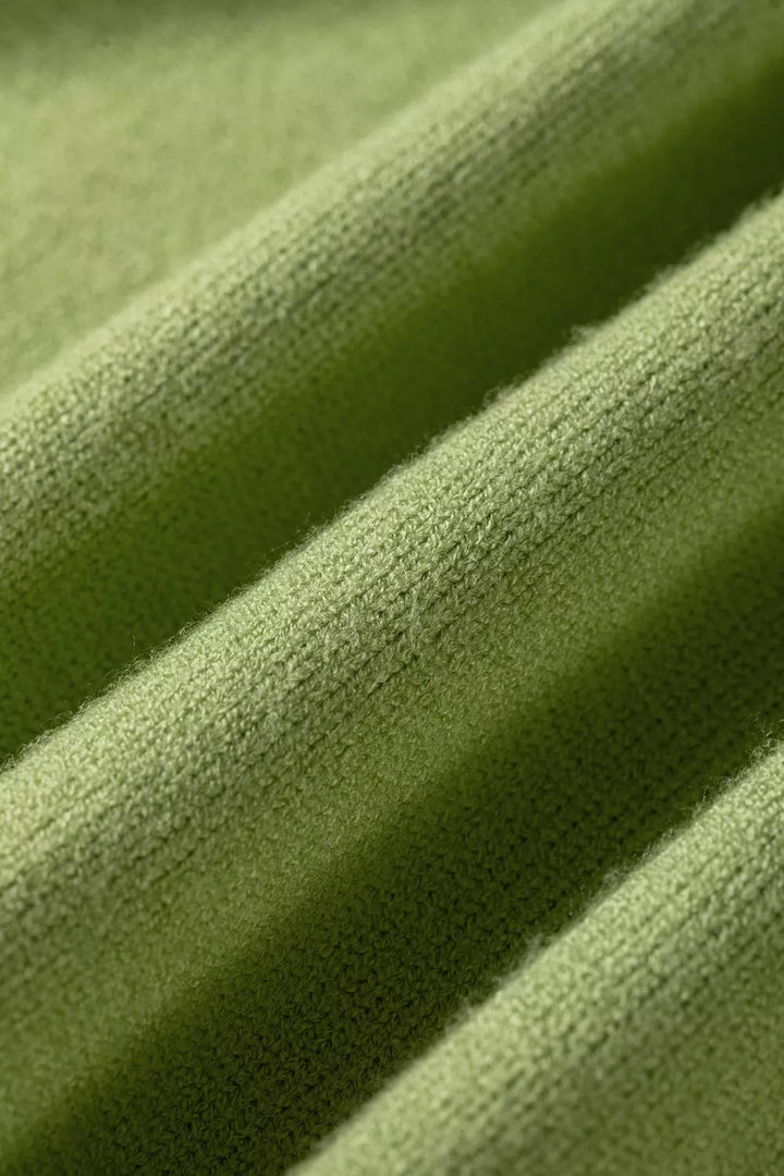 Close-up of the soft knit texture on the pistachio green sweater