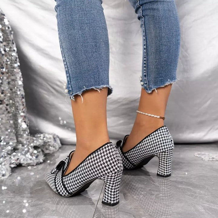 Rear view of the black houndstooth pumps showing the block heel and bow