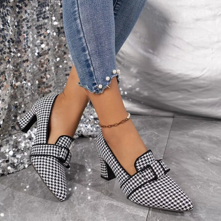 Black houndstooth block heel pump with buckle detail, angled side view