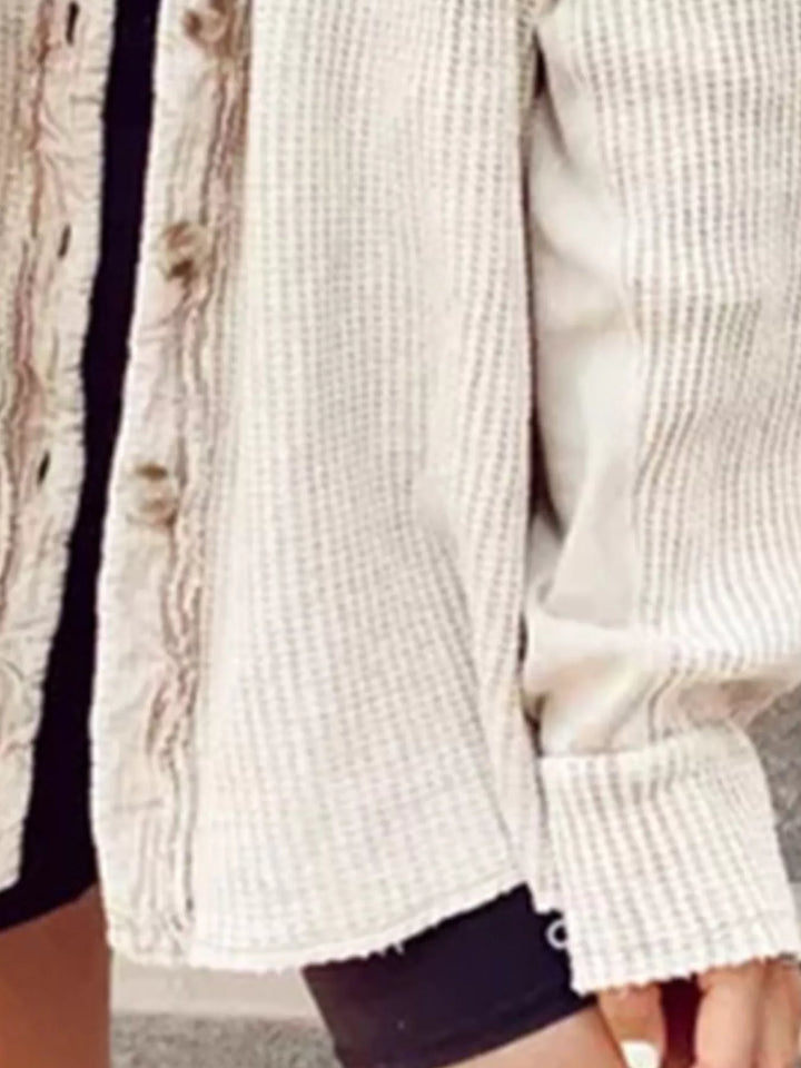 Close-up of the apricot waffle knit shacket placket, buttons and ribbed cuff