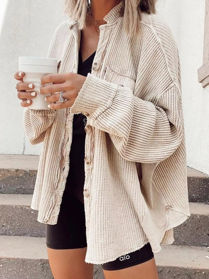 Women's shacket in apricot, oversized waffle knit button up worn open over a black top