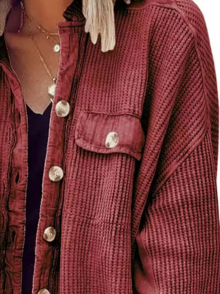 Detail of the burgundy shacket chest pocket and button placket texture