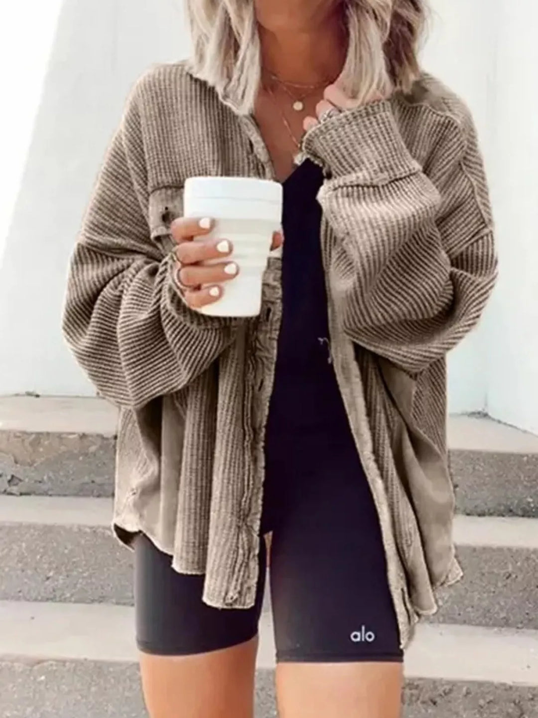Khaki oversized shacket draped open, relaxed look with a coffee in hand
