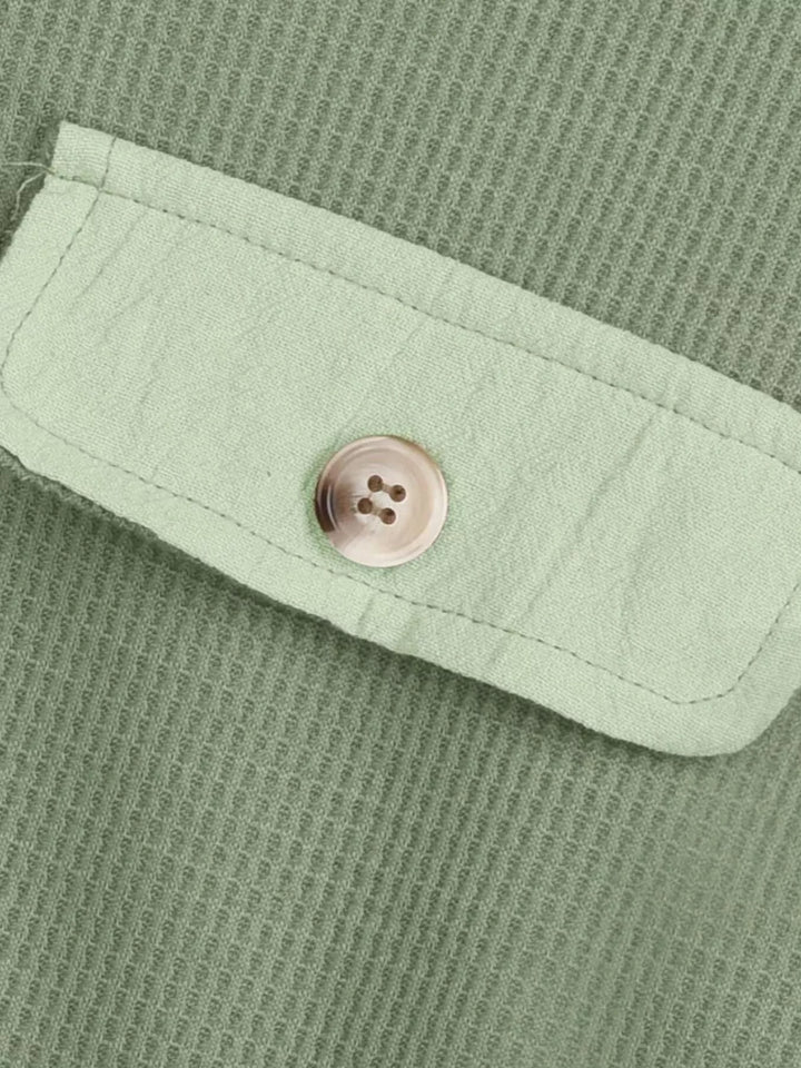 Light green waffle texture and button flap pocket up close